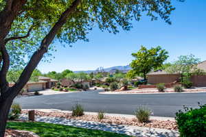 View of asphalt road with a residential and a mountain view
