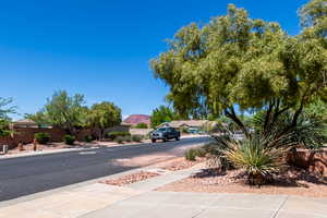 View of street with sidewalks, curbs, and a mountain view