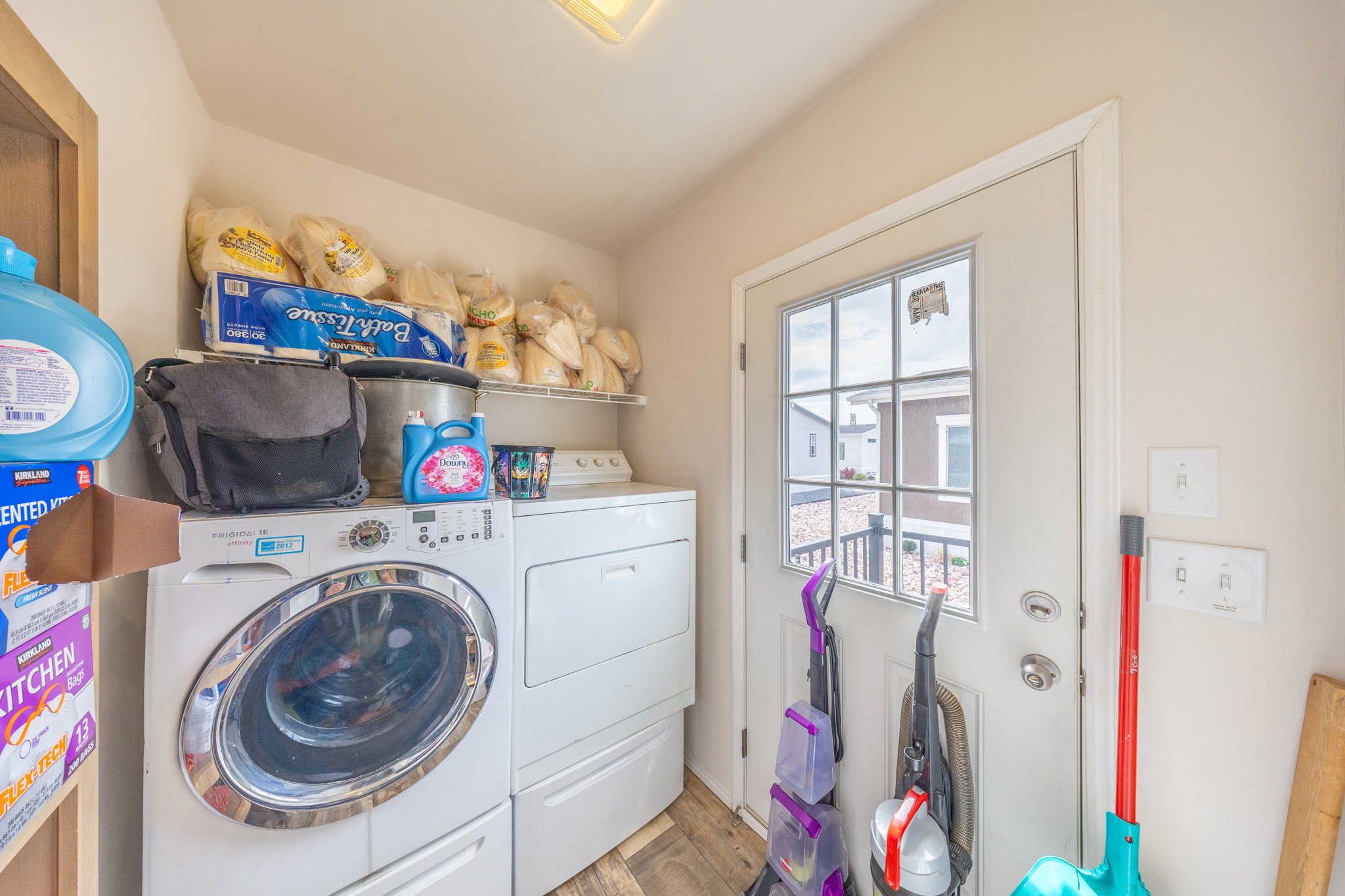 Laundry area with washing machine and clothes dryer and light wood-style floors