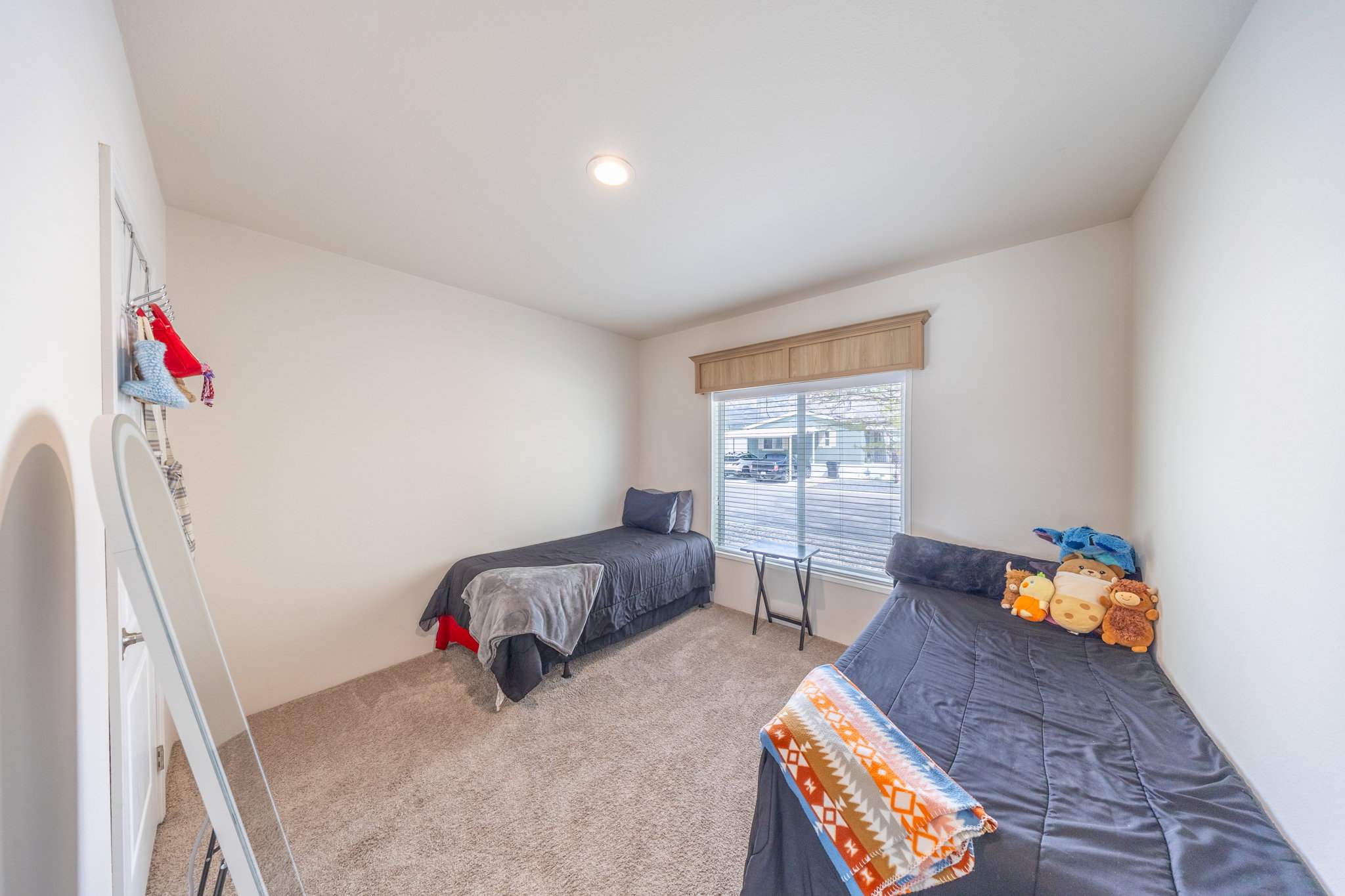 Bedroom featuring light carpet