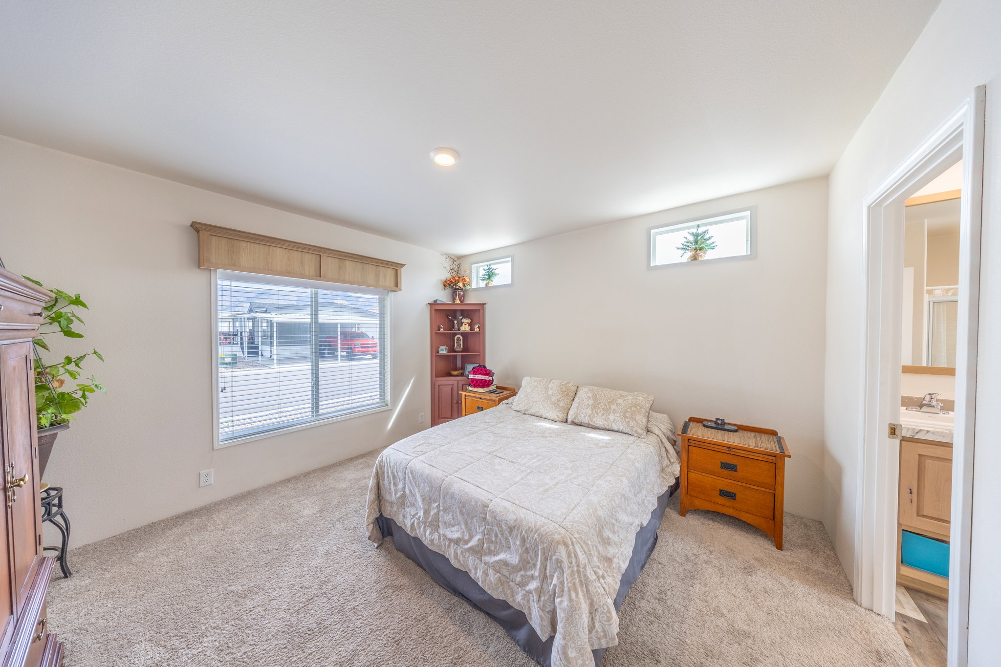 Primary Bedroom featuring light carpet and a sink