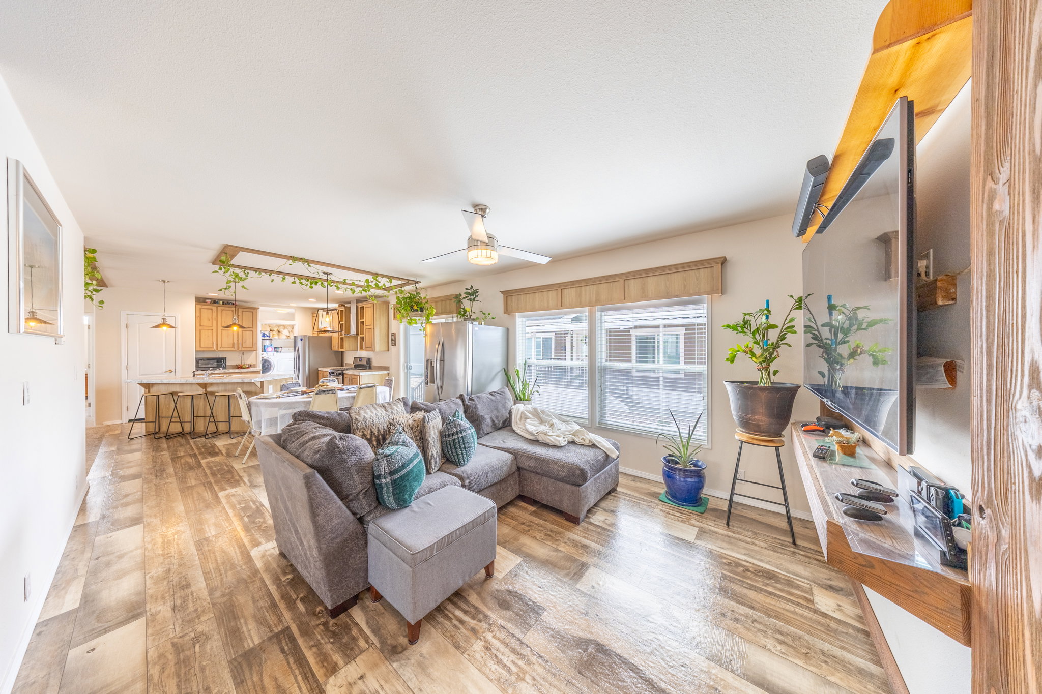 Living area with light wood-style floors and ceiling fan