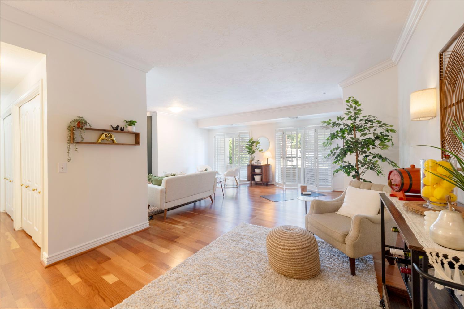 Hardwood-finish flooring throughout, crown molding, and bright white walls