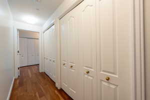 Hall featuring dark wood-style floors and baseboards