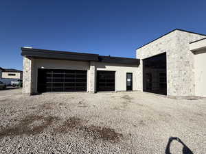 Garage with gravel driveway