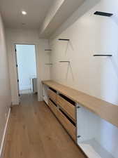 Hall featuring light wood finished floors and recessed lighting