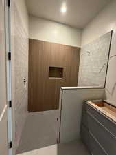 Bathroom with walk in shower, vanity, recessed lighting, and light tile patterned floors