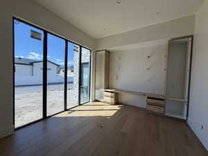 Unfurnished room with light wood-style flooring and built in study area