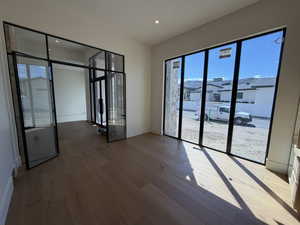 Spare room featuring dark wood-type flooring and recessed lighting