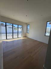 Spare room featuring dark wood-style floors and recessed lighting