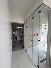 Corridor with a sauna / steam room and baseboards