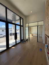 Unfurnished bedroom with dark wood-style flooring and multiple windows