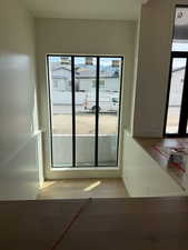 Doorway to outside with wood finished floors and baseboards