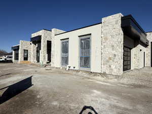 View of front of property with stone siding and stucco siding
