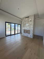 Unfurnished living room featuring a fireplace and light wood-style flooring