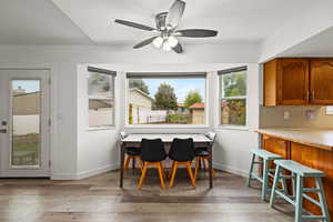 Dining space with light wood finished floors and a ceiling fan