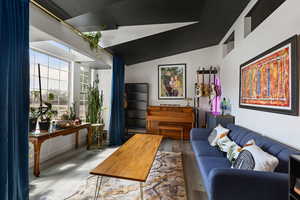 Living room with wood finished floors and lofted ceiling