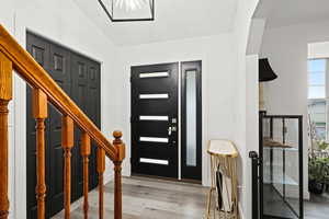 Entryway featuring vaulted ceiling and light wood-style flooring