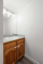 Bathroom featuring vanity and dark wood-style flooring