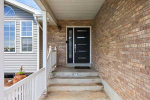 Doorway to property with brick siding