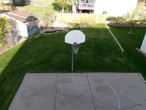 View from balcony - Fenced backyard with basketball hoop and a balcony