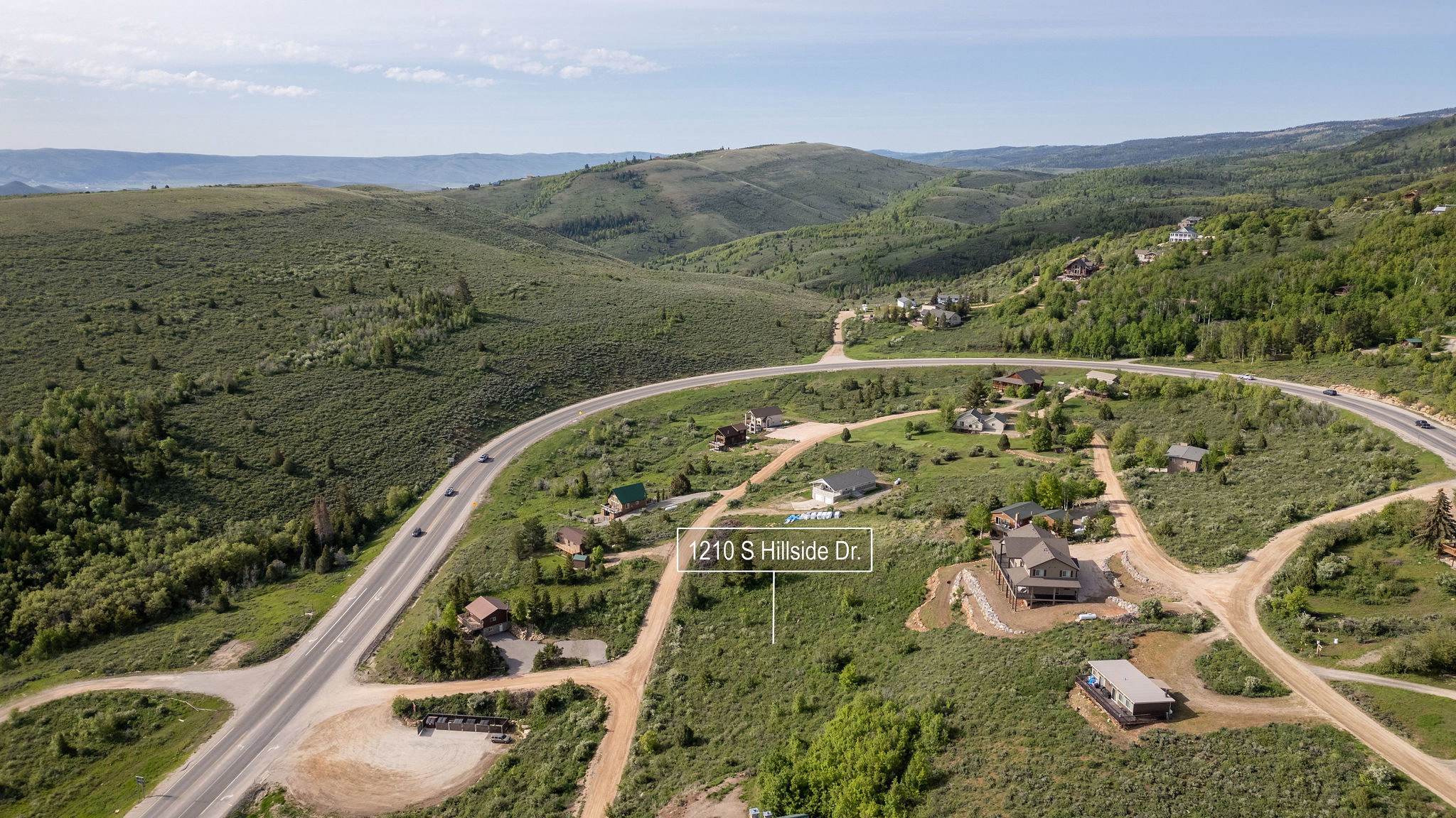 Aerial view of property's location featuring property parcel outlined and a mountain backdrop