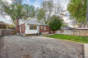 Back of house with a gate, a patio, a fenced backyard, and a chimney