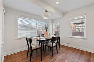 Dining space with wood finished floors, plenty of natural light, and recessed lighting