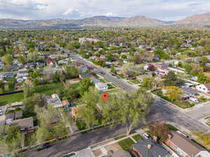 Aerial view of property's location featuring nearby suburban area and a mountain backdrop
