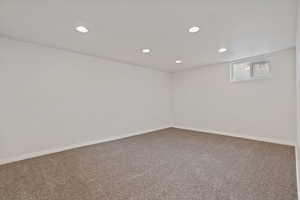 Basement with recessed lighting and carpet floors