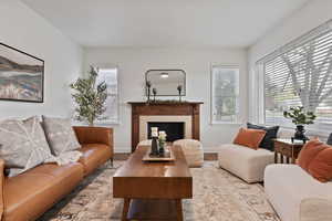 Living room with a tiled fireplace and wood finished floors