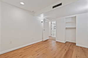 Unfurnished room with light wood finished floors and recessed lighting
