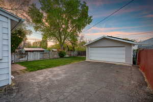 Garage at dusk featuring a garage
