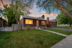 Bungalow-style house with brick siding and a chimney