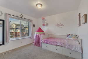 Bedroom with light colored carpet and baseboards