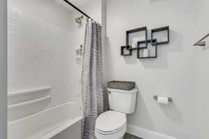 Full bathroom featuring toilet and shower / tub combo