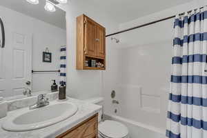 Full bathroom featuring vanity and shower / tub combo with curtain