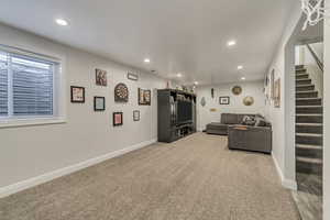 Living room with recessed lighting and light colored carpet