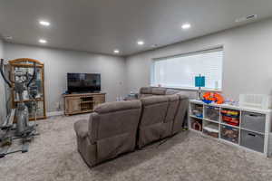 Carpeted living area featuring recessed lighting