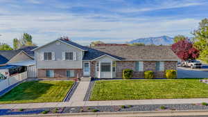 Tri-level home featuring brick siding and a mountain view