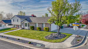 View of front of property with brick siding, a shingled roof, concrete driveway, and an attached garage