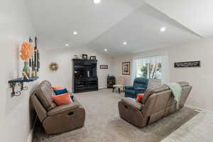 Spacious Great Room with light carpet, recessed lighting, and vaulted ceiling
