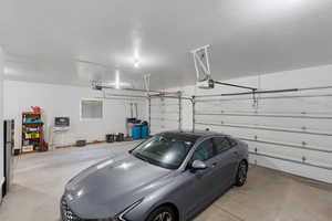 Garage featuring double and single garage doors and garage door openers