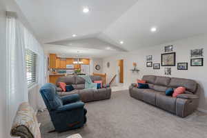 Great Room area featuring light carpet, vaulted ceiling, and recessed lighting
