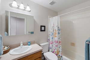 Full bathroom with vanity and shower / tub combo with curtain