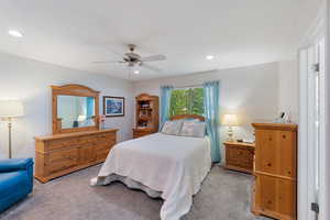 Carpeted Primary bedroom with ceiling fan, recessed lighting, and a linear walk - in closet