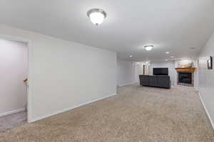 Unfurnished living room space, ceiling lights, and light colored carpet