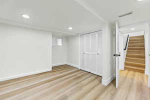 Unfurnished bedroom with light wood-style flooring, a closet, and recessed lighting