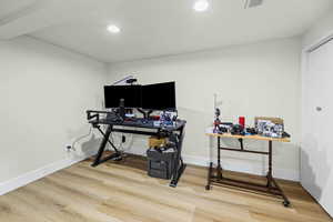 Office space with light wood-type flooring and recessed lighting