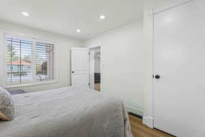 Bedroom with wood finished floors and recessed lighting